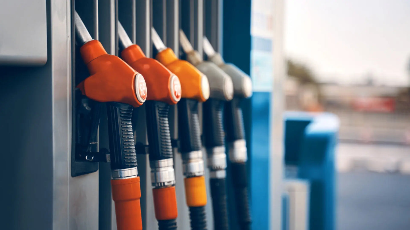 Petrol bowser nozzles lined up at a service station.