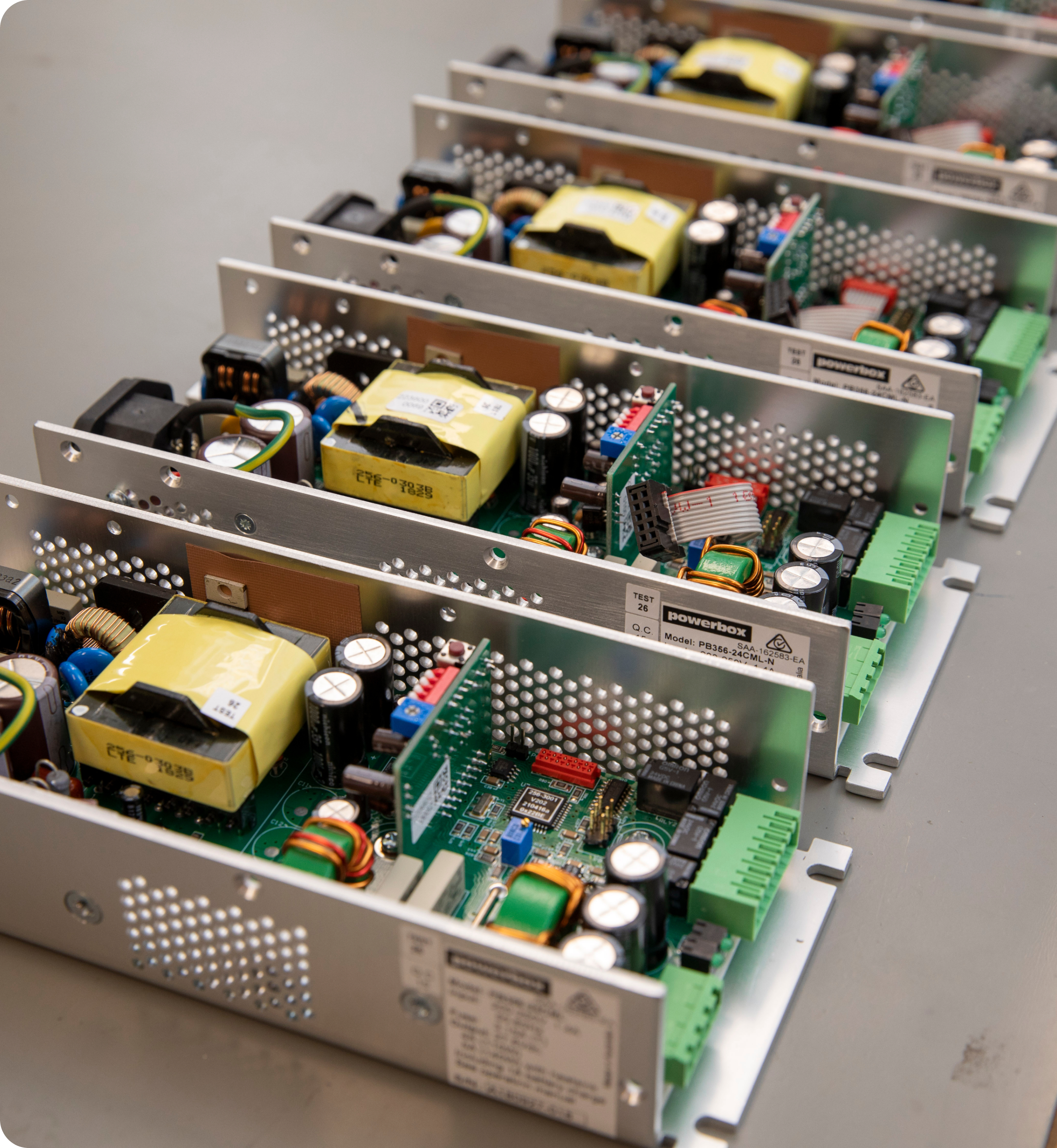 Row of Powerbox power supplies showing circuit boards and components.