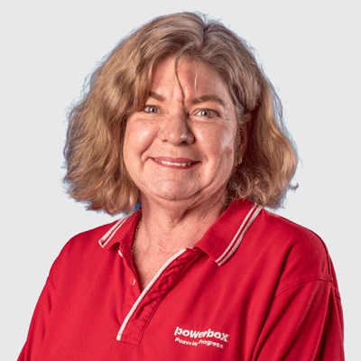 Woman in red Powerbox polo shirt smiling, representing industrial power solutions team