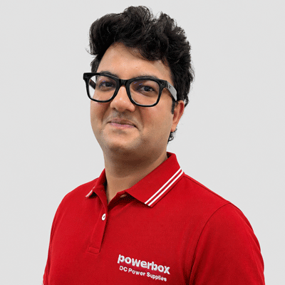 Man in red polo shirt with Powerbox logo, representing industrial power solutions