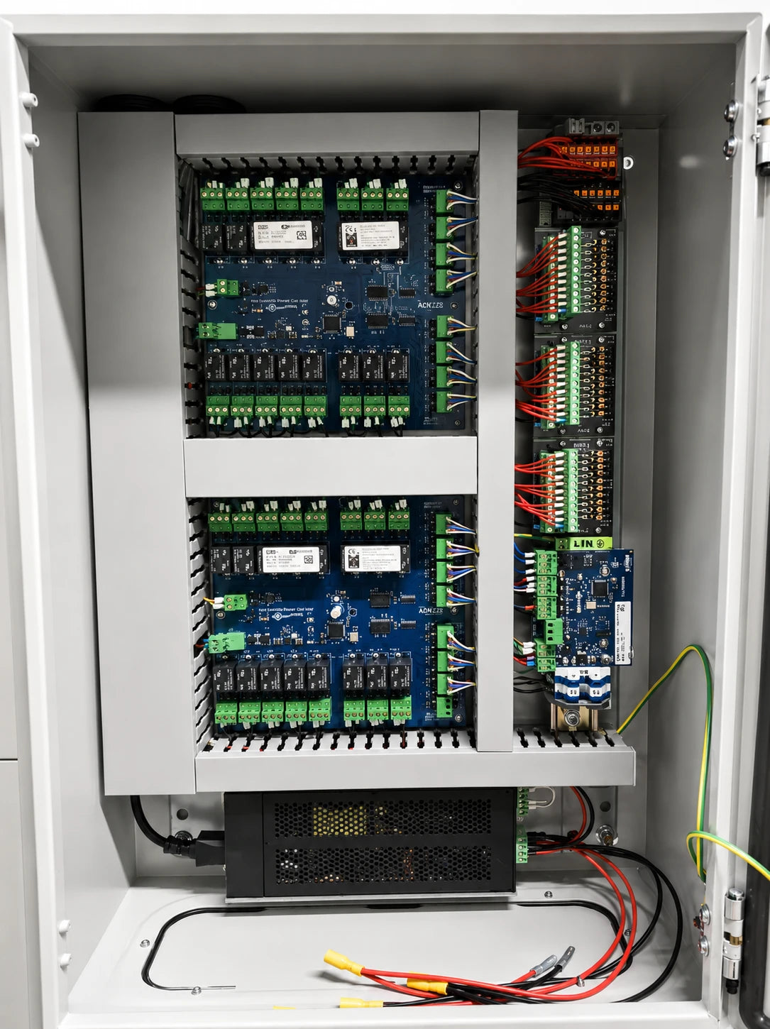 Open industrial electrical control cabinet showing internal control panels, terminal blocks, wiring, and a power supply unit.